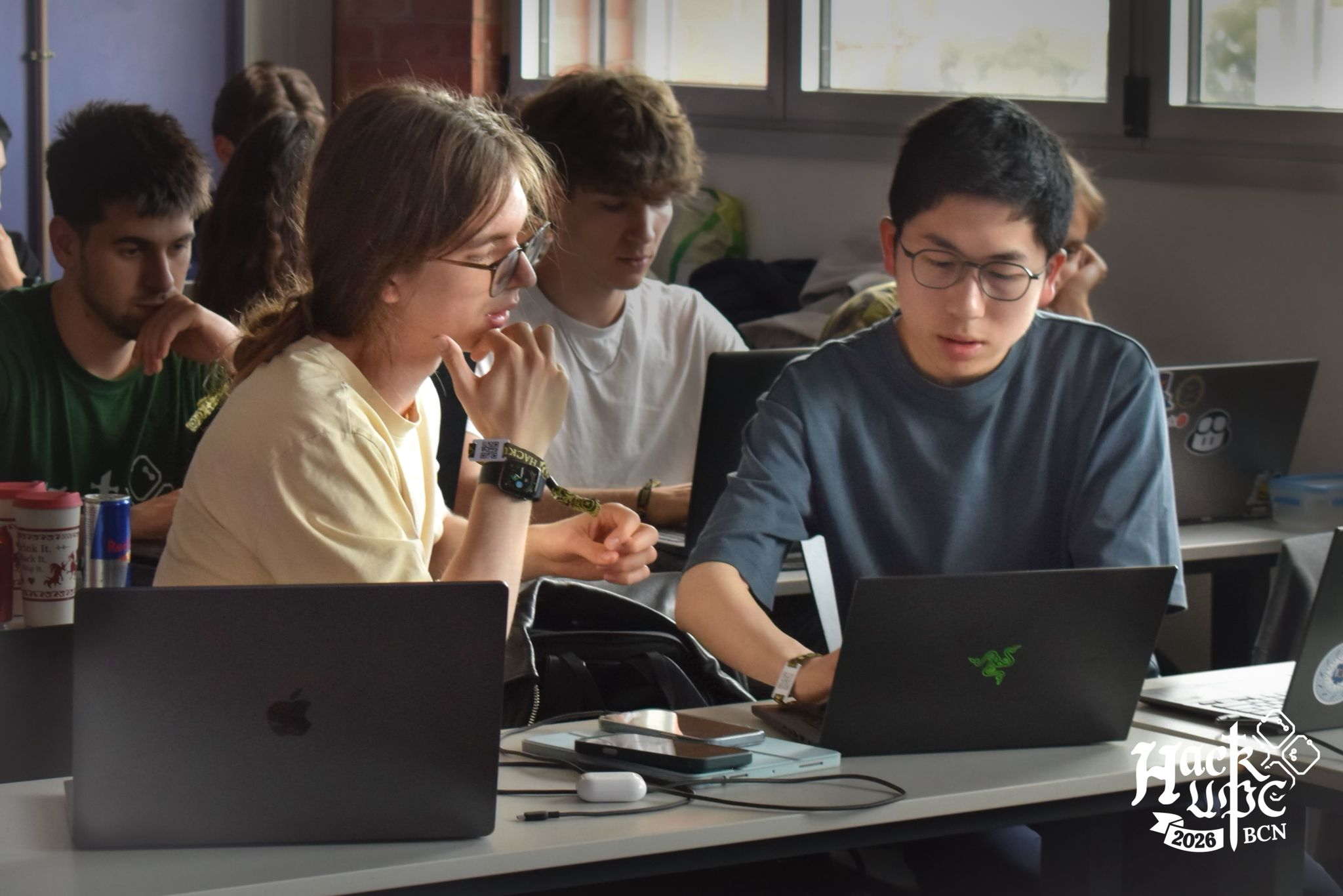 Tom Lam collaborating with teammates at HackUPC 2026